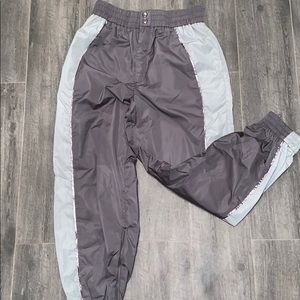 Gray windbreaker/reflective pants.